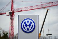 (FILES) This file photo taken on November 09, 2015 shows the logo of German car maker Volkswagen ( VW ) near a cranes of a construction site in Wolfsburg, on November 9, 2015. 
Volkswagen suffered whiplash from a massive engine-rigging scandal as profits slumped in the first quarter, but the embattled German auto giant on May 31, 2016 insisted things were not as bad as they look. / AFP PHOTO / JOHN MACDOUGALL