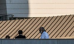 French President Emmanuel Macron (C) visits the specialised infectious diseases hospital IHU in Marseille on April 9, 2020 with its director professor Didier Raoult (R) who has caused controversy within the country's scientific community for insisting the anti-malaria drug chloroquine can beat the novel coronavirus. - Raoult met Macron in a visit that was not announced in advance, the French presidency said. French presidential officials also said that Macron intends to consult a broad spectrum of voices before giving his third address to the nation on the coronavirus epidemic on April 13. (Photo by Anne-Christine POUJOULAT / AFP)