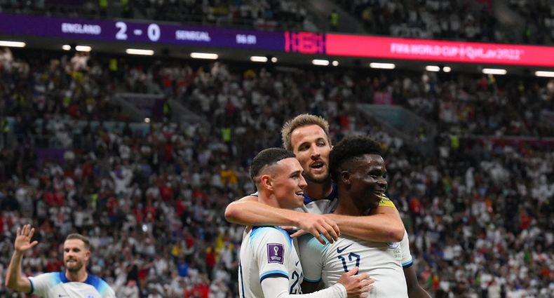 CORRECTION / England's forward #17 Bukayo Saka celebrates with England's forward #20 Phil Foden (L) and England's forward #09 Harry Kane after scoring his team's third goal during the Qatar 2022 World Cup round of 16 football match between England and Senegal at the Al-Bayt Stadium in Al Khor, north of Doha on December 4, 2022. (Photo by Paul ELLIS / AFP) / �The erroneous mention[s] appearing in the metadata of this photo by Paul ELLIS has been modified in AFP systems in the following manner: [England's forward #17 Bukayo Saka] instead of [Senegal's midfielder #17 Pape Matar Sarr]. Please immediately remove the erroneous mention from all your online services and delete it from your servers. If you have been authorized by AFP to distribute it to third parties, please ensure that the same actions are carried out by them. Failure to promptly comply with these instructions will entail liability on your part for any continued or post notification usage. Therefore we thank you very much for all your attention and prompt action. We are sorry for the inconvenience this notification may cause and remain at your disposal for any further information you may require.�