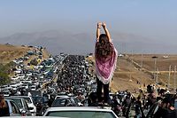 -- AFP PICTURES OF THE YEAR 2022 --

This UGC image posted on Twitter reportedly on October 26, 2022 shows an unveiled woman standing on top of a vehicle as thousands make their way towards Aichi cemetery in Saqez, Mahsa Amini's home town in the western Iranian province of Kurdistan, to mark 40 days since her death, defying heightened security measures as part of a bloody crackdown on women-led protests. - A wave of unrest has rocked Iran since 22-year-old Amini died on September 16 following her arrest by the morality police in Tehran for allegedly breaching the country's strict rules on hijab headscarves and modest clothing. (Photo by UGC / AFP) / AFP PICTURES OF THE YEAR 2022

=== RESTRICTED TO EDITORIAL USE - MANDATORY CREDIT "AFP PHOTO / UGC IMAGE" - NO MARKETING NO ADVERTISING CAMPAIGNS - DISTRIBUTED AS A SERVICE TO CLIENTS FROM ALTERNATIVE SOURCES, AFP IS NOT RESPONSIBLE FOR ANY DIGITAL ALTERATIONS TO THE PICTURE'S EDITORIAL CONTENT, DATE AND LOCATION WHICH CANNOT BE INDEPENDENTLY VERIFIED === / 