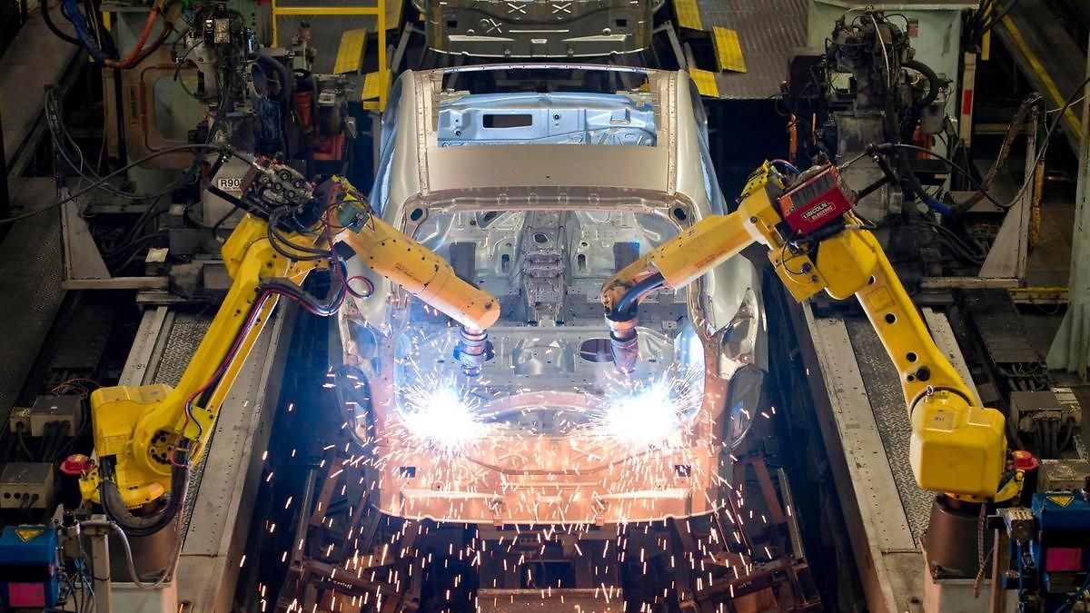 Robots weld vehicle panels at a Nissan plant Photo: AFP