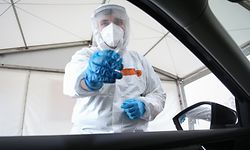 19.04.2021, Niedersachsen, Osnabrück: Der Mitarbeiter einer Corona Drive-In-Teststation steht neben einem geöffneten Autofenster, um einen Nasen-Abstrich zu nehmen. Für die Testung können online Termine vereinbart werden. Das Ergebnis wird nach kurzer Wartezeit per Email mitgeteilt. Mit dem "Bürgertest" haben alle Einwohner Deutschlands die Möglichkeit, sich kostenlos auf eine Infektion mit dem Corona-Virus testen zu lassen. Foto: Friso Gentsch/dpa +++ dpa-Bildfunk +++