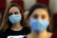 Christian worshippers attend a mass while wearing protective masks due to the COVID-19 pandemic at the Mart Shmoni church in Arbil, the capital of the autonomous Kurdish region of northern Iraq, on May 17, 2020. (Photo by SAFIN HAMED / AFP)