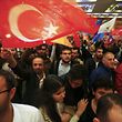 People wave flags outside the AK Party headquarters in Istanbul, Turkey November 1, 2015. Turks went to the polls in a snap parliamentary election on Sunday under the shadow of mounting internal bloodshed and economic worries, a vote that could determine the trajectory of the polarised country and of President Tayyip Erdogan. The vote is the second in five months, after the AK Party founded by Erdogan lost in June the single-party governing majority it has enjoyed since first coming to power in 2002.  REUTERS/Osman Orsal 