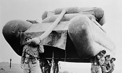 (Original Caption) A handful of British tommies on maneuvers at Salisbury Plain nonchalantly hoist an enormous tank on their shoulders and move it to another part of the "battleground." A Herculean feat? Well, not exactly: The tank is only inflated rubber, one of the several dummy weapons skillfully deployed to baffle the enemy. Some 12,000 men and 4,000 vehicles (real ones) of Britain's territorial army, roughly equivalent to the United States' National Guard, took part in the fall maneuvers.