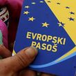 A volunteer holds up a mock European passport during a campaign by the Centre for Promotion of Civil Society in Sarajevo in this December 21, 2010 file photo. Bosnia has applied to join the European Union, the bloc's top diplomat Federica Mogherini said on February 15, 2016 though Brussels signalled Sarajevo has not met all conditions to submit the application.  REUTERS/Danilo Krstanovic/Files