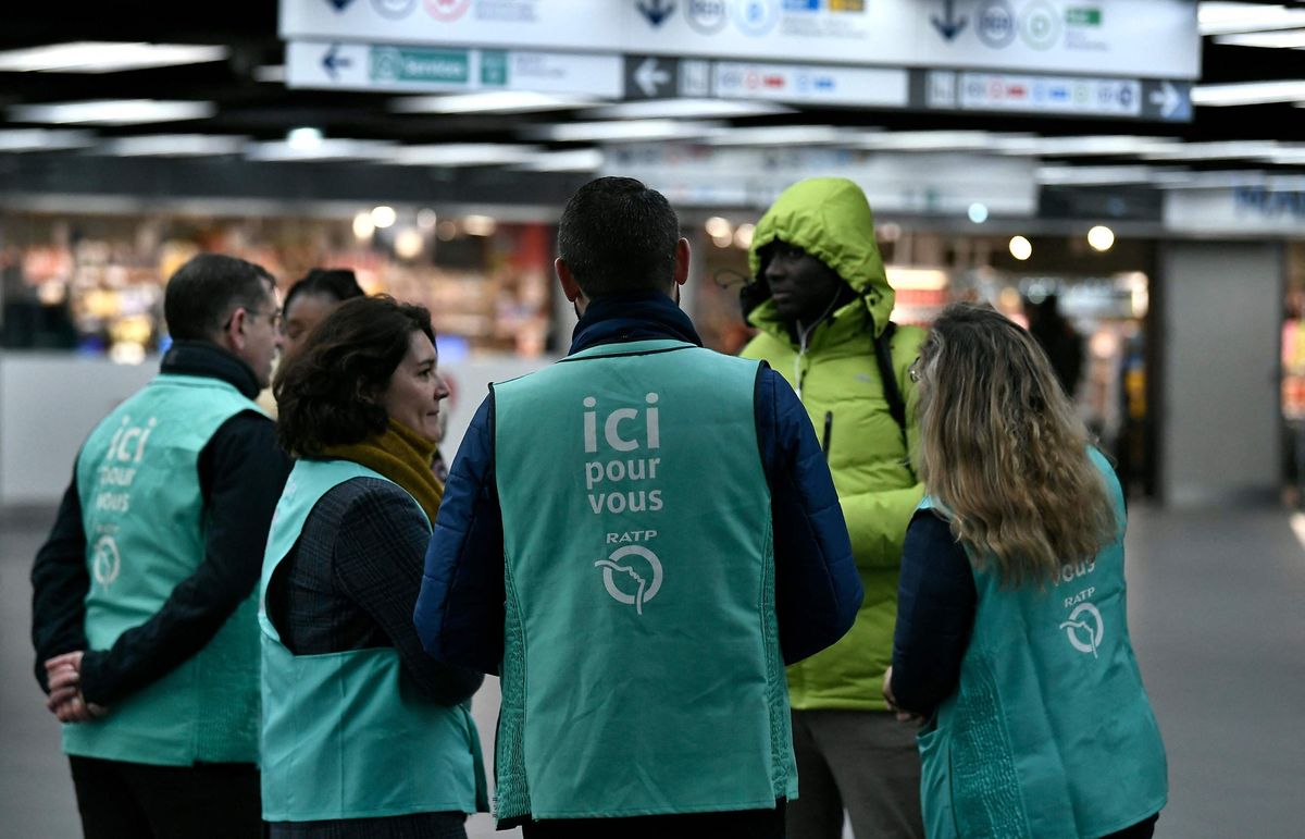 RATP staff wearing jackets reading "here to help you" work at Chatelet-Les Halles metro station in Paris.