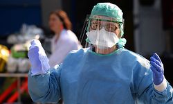 A nurse anesthetist gestures during the disinfection of ambulances which carried six coronavirus patients at the Brest hospital, evacuated by air from the French eastern city of Mulhouse, in Brest, western France, on March 24, 2020, on the eight day of a lockdown aimed at curbing the spread of the COVID-19 (novel coronavirus) in France. (Photo by JEAN-FRANCOIS MONIER / AFP)