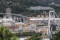 This general view taken on August 15, 2018, shows abandoned vehicles on the Morandi motorway bridge the day after a section collapsed in the north-western Italian city of Genoa. - At least 38 people were killed on August 14, when the giant motorway bridge collapsed in Genoa in northwestern Italy. The collapse, which saw a vast stretch of the A10 freeway tumble on to railway lines in the northern port city, was the deadliest bridge failure in Italy for years, and the country's deputy transport minister warned the death toll could climb further. (Photo by Valery HACHE / Piero CRUCIATTI / AFP / AFP)