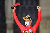 Team Jumbo's Slovenian rider Primoz Roglic celebrates on the podium with the overall leader's red jersey after winning the 1st stage of the 2021 La Vuelta cycling tour of Spain, an 7,1 individual time-trial race from Burgos to Burgos, on August 14, 2021. (Photo by ANDER GILLENEA / AFP)