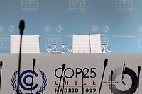 Empty chairs are pictured on the last day of the UN Climate Change Conference COP25 at the 'IFEMA - Feria de Madrid' exhibition centre, in Madrid, on December 13, 2019. - The preservation of Earth's pristine wildernesses and oceans, long treated as a separate issue to curbing climate change, is taking on more importance as scientists say they really need to go hand in hand. While the focus at COP25 in Madrid these past two weeks has been on climate change and the growing urgency to cut greenhouse gas emissions, organisers have made an effort to put the natural environment into the mix. (Photo by CRISTINA QUICLER / AFP)