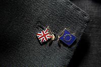 (FILES) In this file photo taken on March 23, 2017 A photo-illustration depicting a lapel of a suit adorned with a severed pin badge featuring the EU flag and the Union flag is pictured near Manchester, northern England.. - Four and a half years after Britain voted to leave the EU and as eight months of painstaking trade talks reach a climax, Boris Johnson is set on December 13, 2020, to answer the most fundamental question: what is Brexit? Britain left the EU in January and is in a standstill transition period until December 31 while both sides thrash out the terms of their new trading relationship. (Photo by Oli SCARFF / AFP)