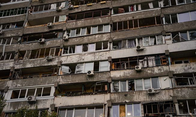 This photograph taken on October 10, 2022, shows a damaged facade of apartments following a missile strike in Dnipro, amid Russia's invasion of Ukraine. - 