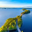 Aerial view of Pulkkilanharju Ridge, Paijanne National Park, southern part of Lake Paijanne. Landscape with drone. Blue lakes, road and green forests from above on a sunny summer day in Finland