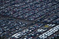 (FILES) In this aerial file photo taken on May 08, 2020 new cars for sale are parked at the harbour of Duisburg, western Germany. - German exports soared past pre-pandemic levels in June for the first time since the coronavirus crisis wreaked havoc on trade, official data showed August 9, 2021, as the industry shrugged off supply chain shortages.The pandemic has severely disrupted global supply chains, leading to shortage in raw materials or components including timber, plastics and steel. (Photo by Ina FASSBENDER / AFP)