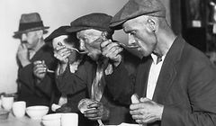 (Original Caption) The Great Depression in the U.S.: Men eating bread and soup in a breadline. Undated photograph.BPA2# 1048