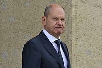 German Chancellor Olaf Scholz grimaces as he leaves the 13th Petersberg Climate Dialogue meeting on July 18, 2022 at the Foreign Ministry in Berlin. - The international conference Petersberg Climate Dialogue is a series of annual conferences set to prepare the  UN Climate Change Conferences and the COP conferences. (Photo by John MACDOUGALL / AFP)
