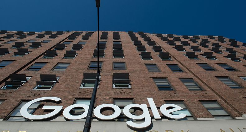 Google's name and logo on a building in New York in 2018.