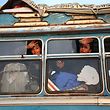 TOPSHOT - Children wave from the window as buses carrying Jaish al-Islam fighters and their families from their former rebel bastion of Douma, arrive at the Abu al-Zindeen checkpoint controlled by Turkish-backed rebel fighters near the northern Syrian town of al-Bab, on April 12, 2018.
Rebels in Syria's Eastern Ghouta surrendered their heavy weapons and their leader left the enclave, a monitor said, signalling the end of one of the bloodiest assaults of Syria's seven-year war. / AFP PHOTO / Nazeer al-Khatib