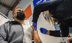 Otto Delcid is inoculated by nurse Nicole Colon with the Pfizer-BioNTech Covid-19 vaccine at the UMass Memorial Health Care COVID-19 Vaccination Center in the Mercantile Center in Worcester, Massachusetts on April 22, 2021. - The center has the capacity to do 600 vaccinations a day and has vaccinated 20,000 people so far as the US celebrates 200,000,000 doses in the US this week. (Photo by Joseph Prezioso / AFP)