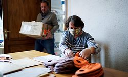 Municipal employees put masks in envelopes to send the town's residents in Lincent on April 28, 2020, during a lockdown in the country aimed at curbing the spread of the COVID-19 pandemic, caused by the novel coronavirus. - Belgian municipalities are starting to provide their residents with washable masks, as the country prepares to ease coronavirus lockdown measures. (Photo by Kenzo TRIBOUILLARD / AFP)