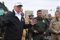US President Donald Trump speaks with Border Patrol agents and next to Sen.John Cornyn(L) R-TX near the Rio Grande after his visit to US Border Patrol McAllen Station in McAllen, Texas, on January 10, 2019. - Trump traveled to the US-Mexico border as part of his all-out offensive to build a wall, a day after he stormed out of negotiations when Democratic opponents refused to agree to fund the project in exchange for an end to a painful government shutdown. (Photo by Jim WATSON / AFP)