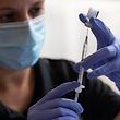 A healthcare worker prepares a Covid-19 vaccine