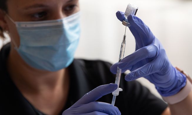 A healthcare worker prepares a Covid-19 vaccine