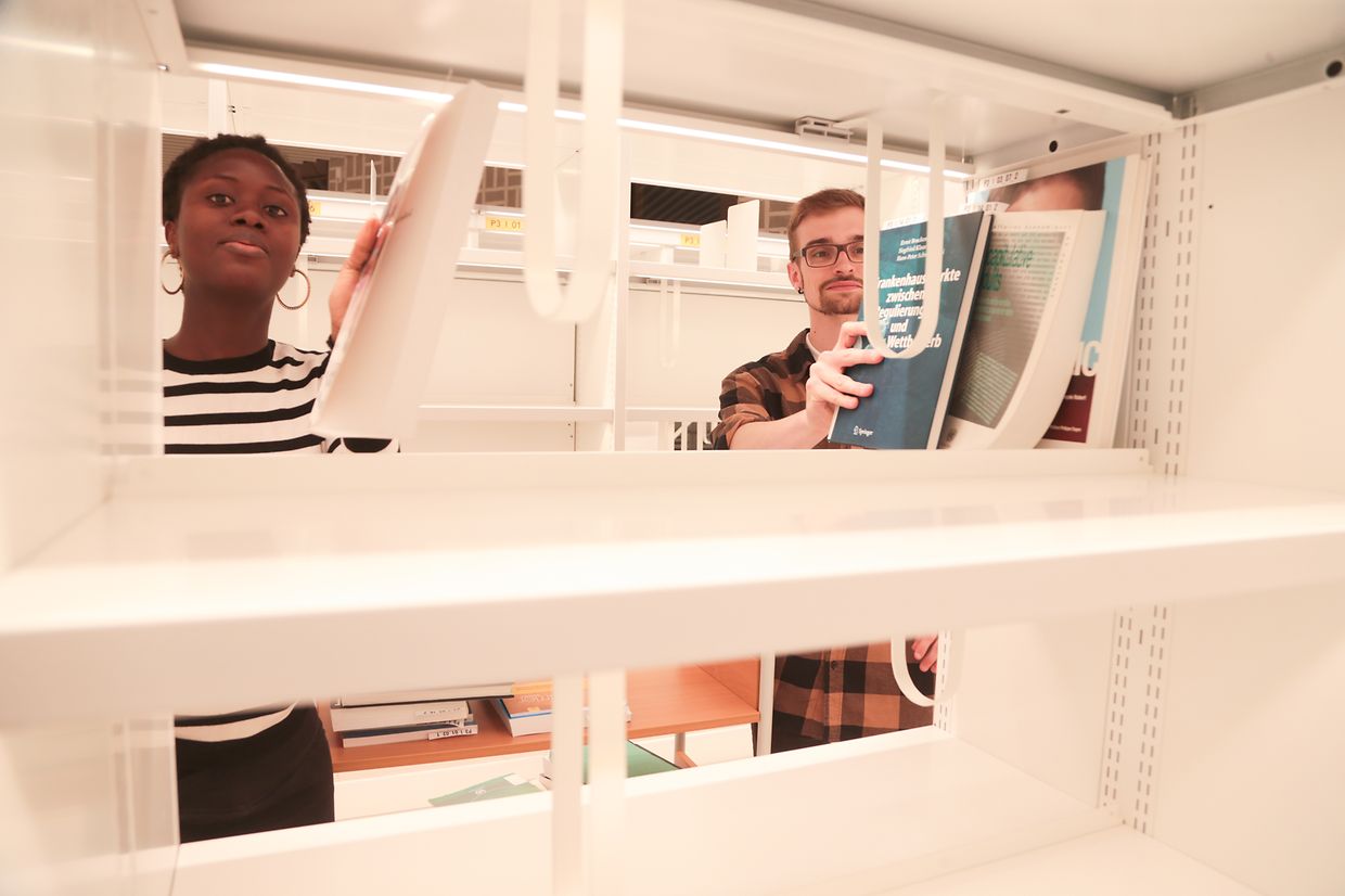 Das Einräumen des Lesesaals soll Mitte Juni abgeschlossen sein. Dann werden Markierungen an den Regalen angebracht und, nach dem Aufstellen der Möbel, auch die Schutzfolien auf dem blauen Teppichboden abgenommen. 
