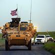 (FILES) In this file photo taken on April 28, 2017 US forces, accompanied by Kurdish People's Protection Units (YPG) fighters, drive their armoured vehicles near the northern Syrian village of Darbasiyah, on the border with Turkey. - The United States is preparing to withdraw its troops from Syria, US media reported on December 19, 2018, a major move that throws into question America's role in the region. (Photo by DELIL SOULEIMAN / AFP)