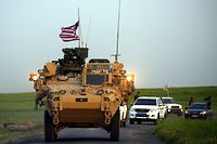 (FILES) In this file photo taken on April 28, 2017 US forces, accompanied by Kurdish People's Protection Units (YPG) fighters, drive their armoured vehicles near the northern Syrian village of Darbasiyah, on the border with Turkey. - The United States is preparing to withdraw its troops from Syria, US media reported on December 19, 2018, a major move that throws into question America's role in the region. (Photo by DELIL SOULEIMAN / AFP)