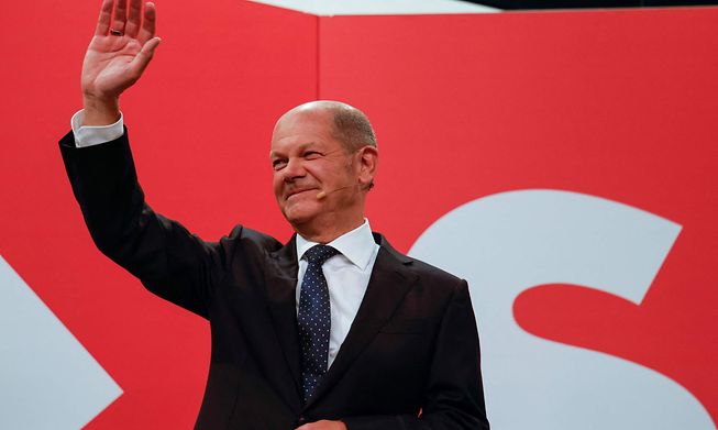 German finance minister and the Social Democrats candidate for chancellor, Olaf Scholz, waves at the party's headquarters after the German general elections on Sunday