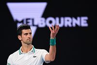 (FILES) In this file photo taken on February 21, 2021, Serbia's Novak Djokovic reacts after a point against Russia's Daniil Medvedev during their men's singles final match on day fourteen of the Australian Open tennis tournament in Melbourne. - Detained tennis world number one Novak Djokovic fought against deportation from Australia on January 6, 2022, after the government revoked his visa for failing to meet pandemic vaccine entry requirements. (Photo by William WEST / AFP) / -- IMAGE RESTRICTED TO EDITORIAL USE - STRICTLY NO COMMERCIAL USE --